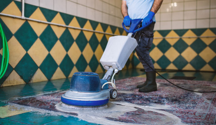 Expert cleaning a rug with professional equipment