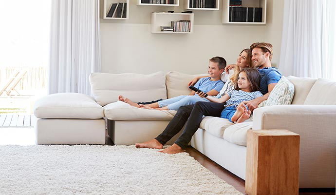 Family sitting on clean sofa