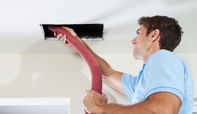 Professional worker cleaning duct