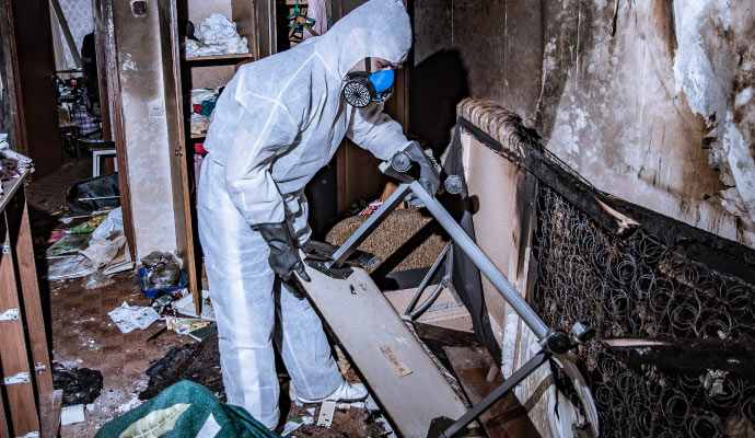 Professional worker restoring a fire damaged room