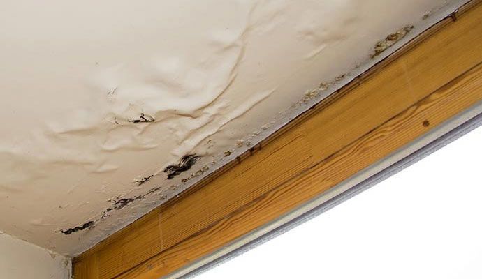 Water-damaged ceiling due to roof leak