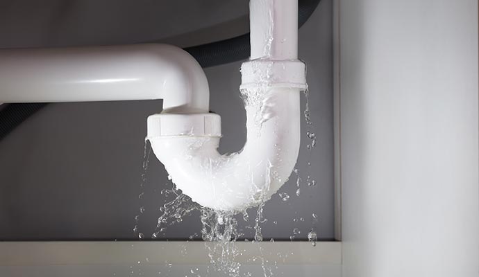 Water leaking from damaged pipe